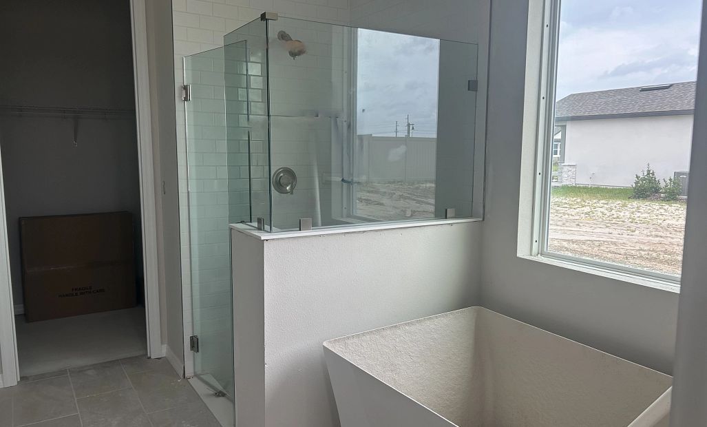 Primary bathroom featuring a freestanding tub and walk-in shower - under construction