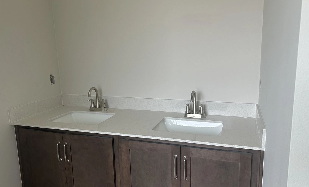 Primary bathroom featuring a double sinks and aspects of AW Collection® Roosevelt - under