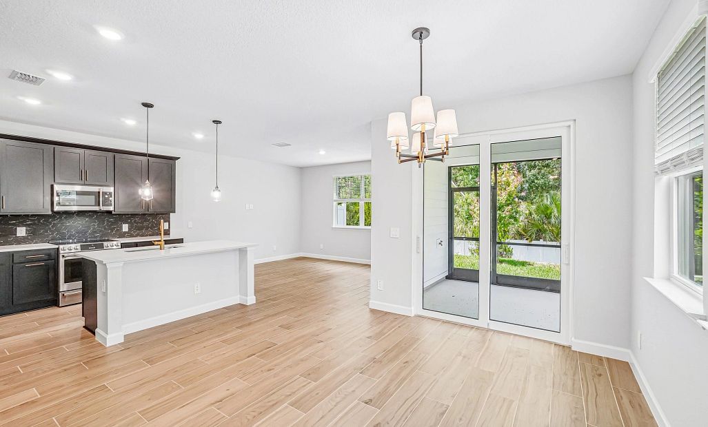 as you walk down the foyer you enter into the open dining, kitchen and family room spaces