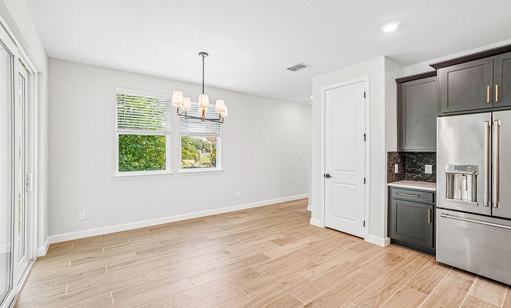 The dining space features two windows and a beautiful light fixture