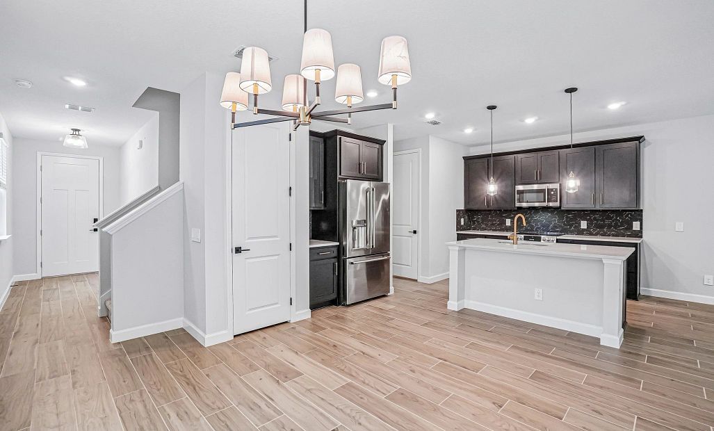 The dining space welcomes you into the stunning kitchen featuring AW Collection® Noir
