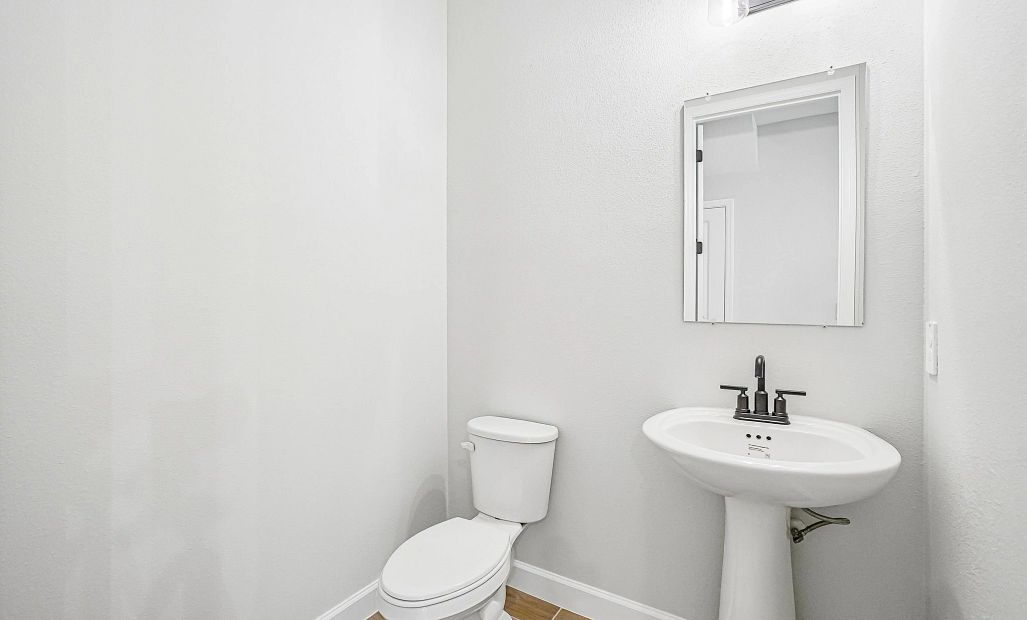 Half bathroom is located off the kitchen near the garage