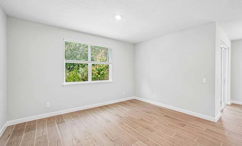 The family room is located off the kitchen and features a double window for excellent lighting