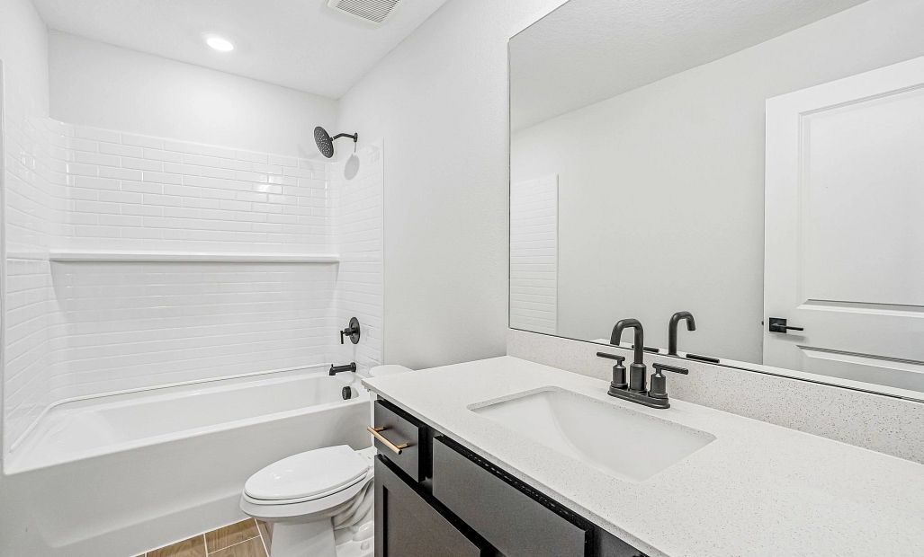 First is the 2nd bathroom located off the main hallway near the secondary bedrooms this bathroom