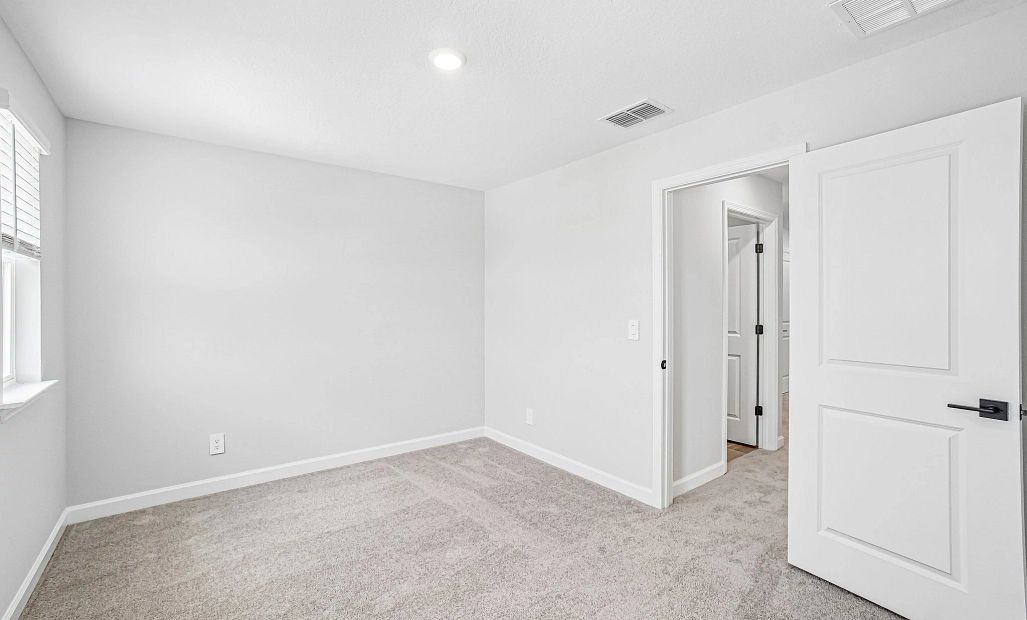 Bedroom 3 is located off the main hallway near the laundry room and features a walk-in closet