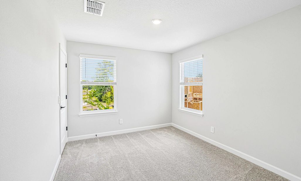 Bedroom 2 is located off the front of the home and features a walk-in closet