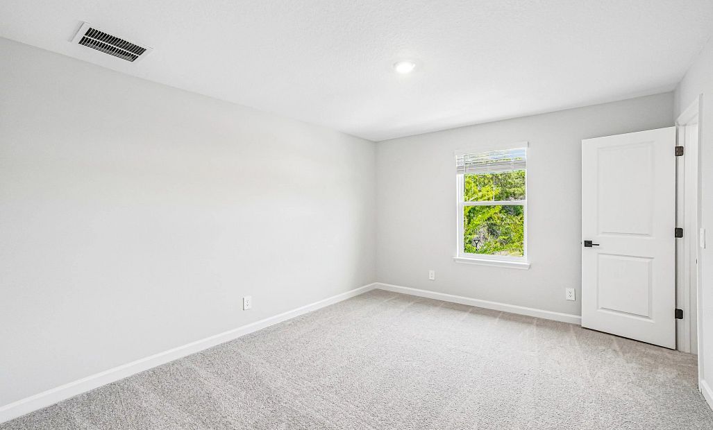 Bedroom 4 is located on the other side of the stairs and features a walk-in closet