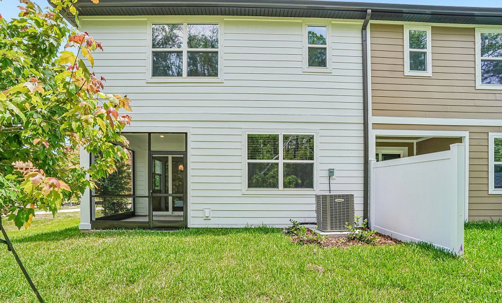 The backyard features a privacy fence
