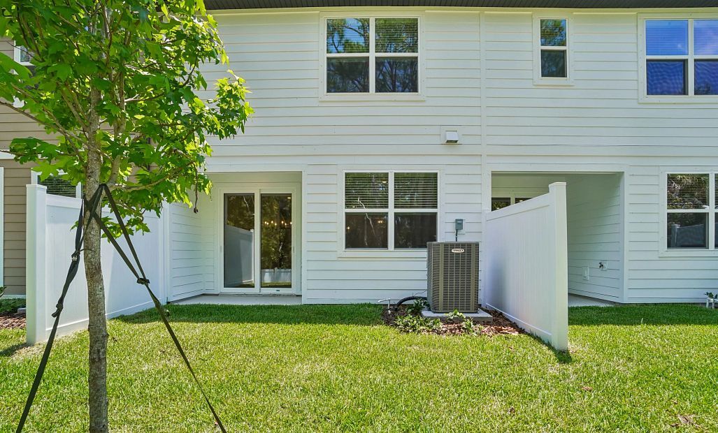 Beautiful backyard space with a covered lanai and privacy fence