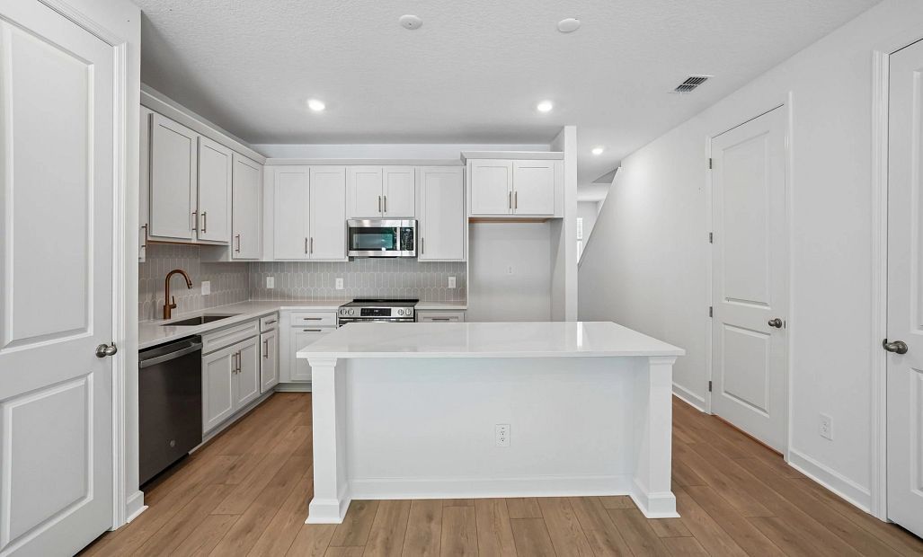 Spacious kitchen featuring a large island and AW Collection® Serene -  representative images