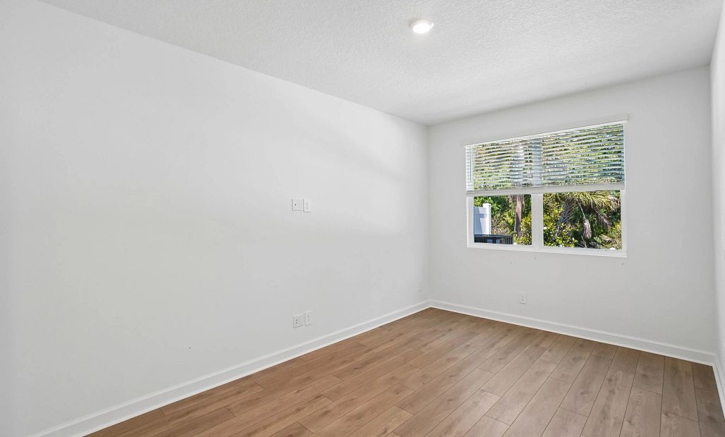 Family room featuring a double window and beautiful tree backdrop -  representative images