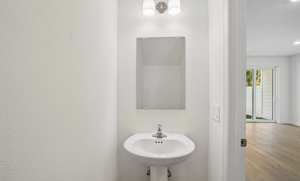Half bathroom located off the kitchen on the first floor -  representative images