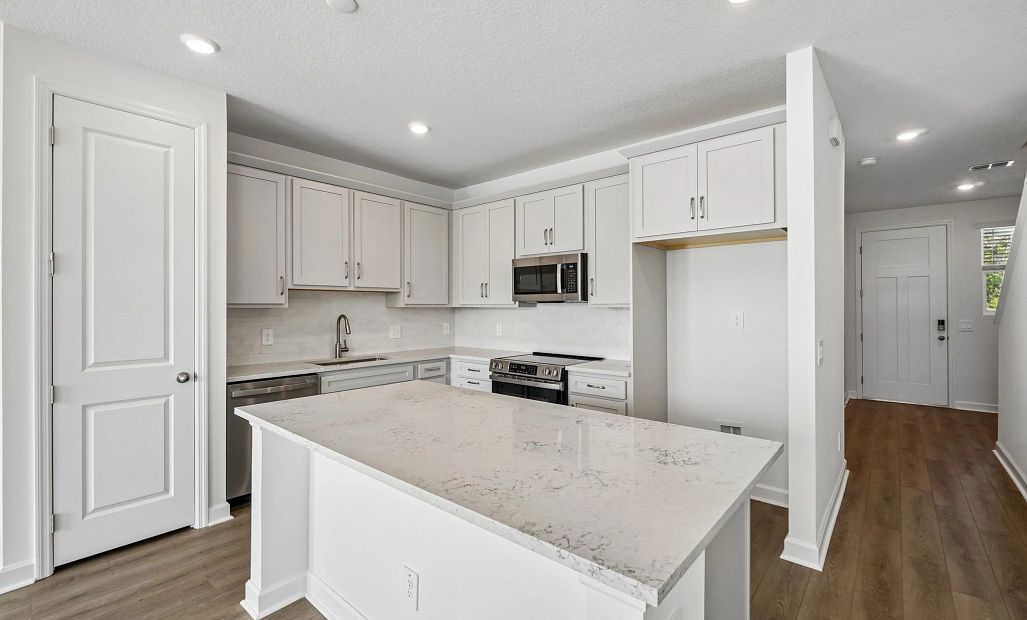 The kitchen featuring the AW Collection® Milan has a large island
