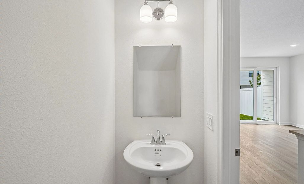Half bathroom located off the kitchen on the first floor