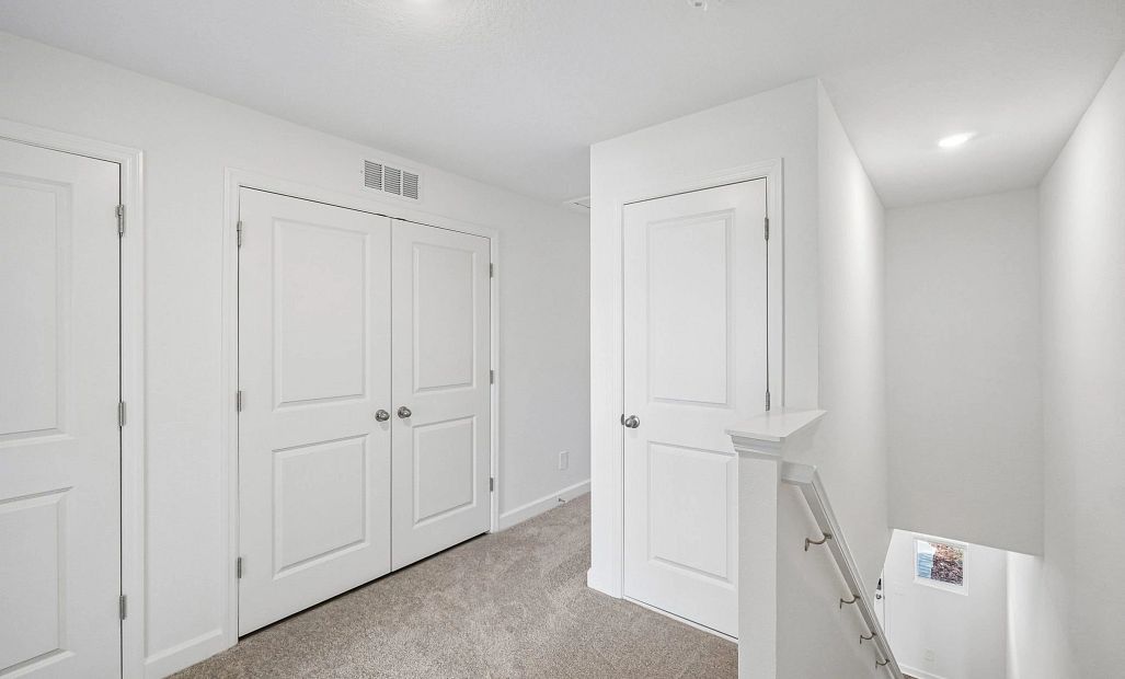 The upstairs loft guides you into the bedroom spaces
