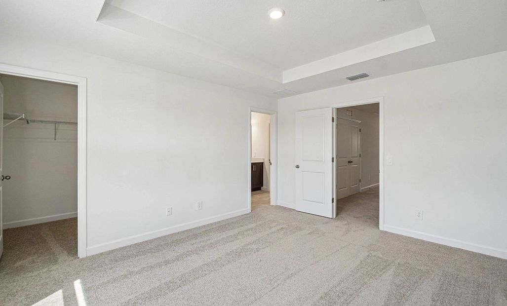 The primary bedroom has a separate walk-in closet and bathroom