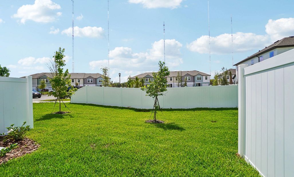 Backyard view features a privacy fence