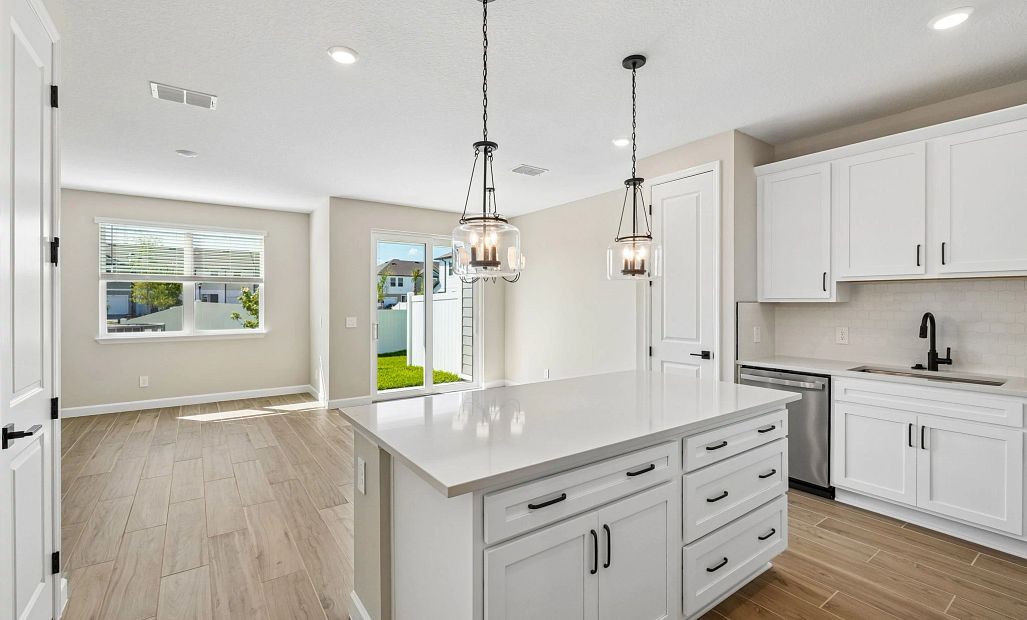 As you walk down the foyer you are welcomed into an open kitchen, dining and family room space