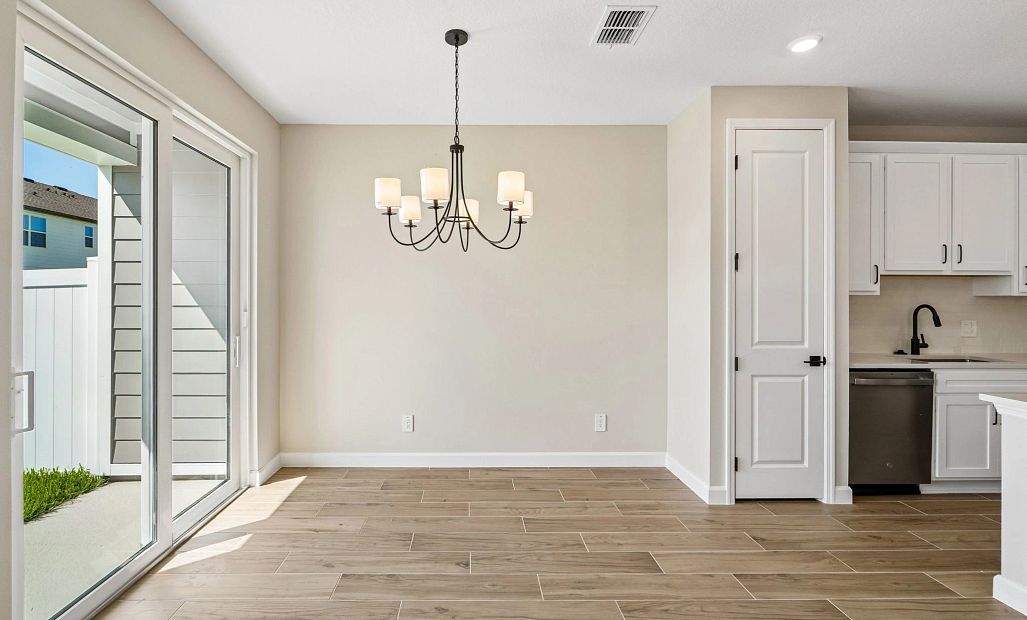 Dining space is located right off the kitchen and looks out on to the covered back lanai