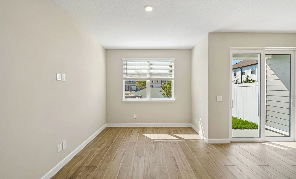 Spacious family room with great lighting coming from the double windows