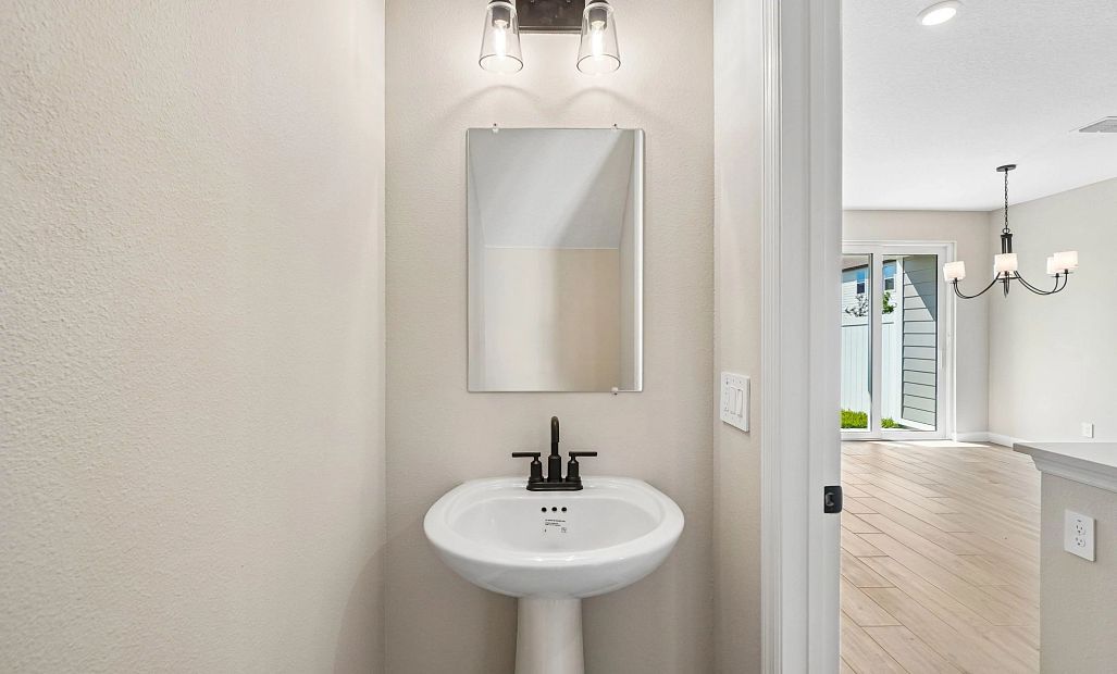 Half bathroom located off the kitchen on the first floor