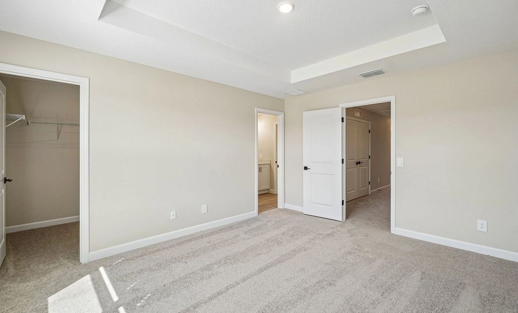 Primary bedroom features a separate walk-in closet and bathroom