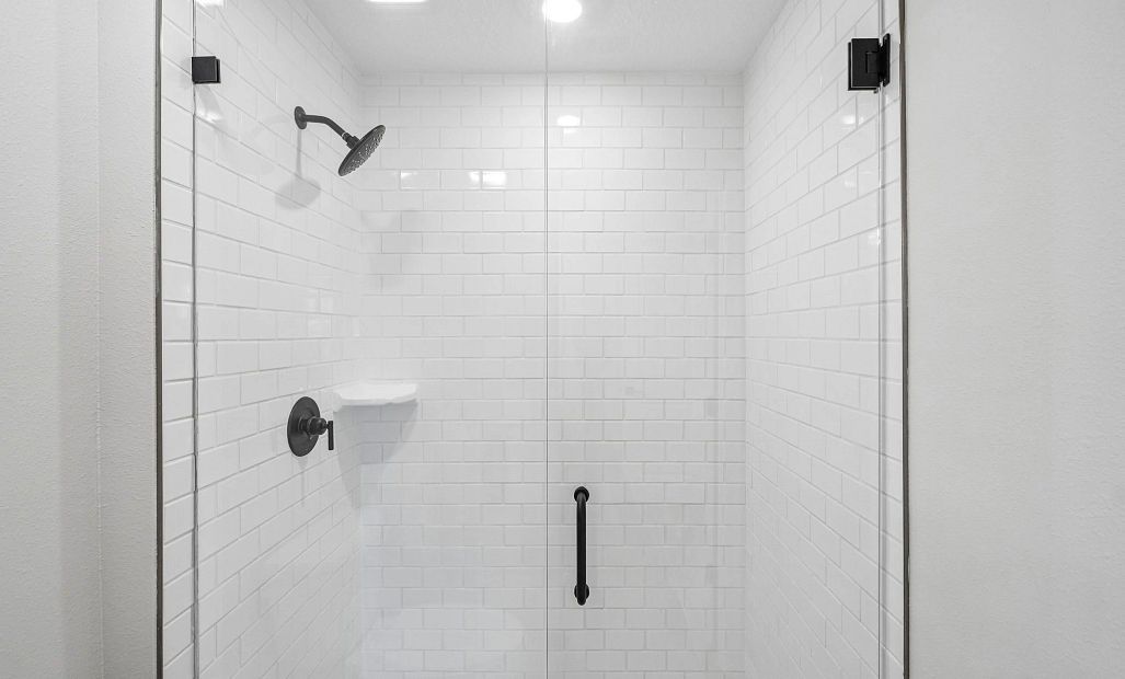 Primary bathroom has a frameless walk-in shower