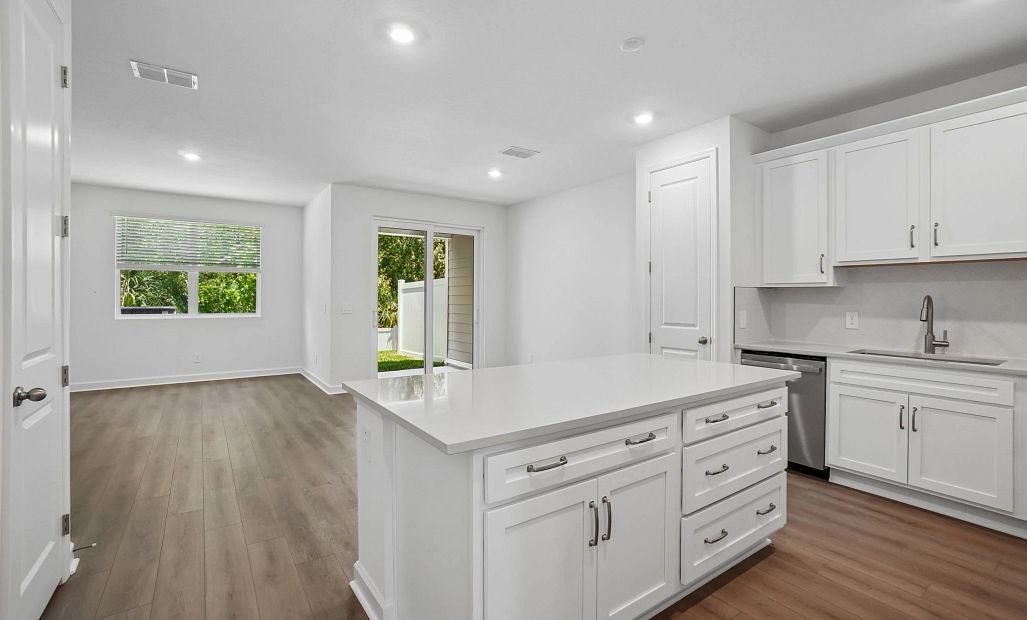 As you walk down the foyer you are welcome into the open concept kitchen, family and dining spaces