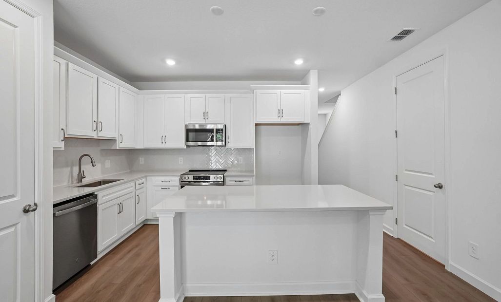 Kitchen featuring our AW Collection® Timeless is anchored by the large island