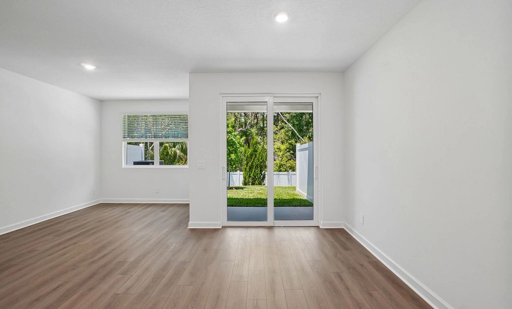 Open dining and family space looking out at the beautiful treed backyard