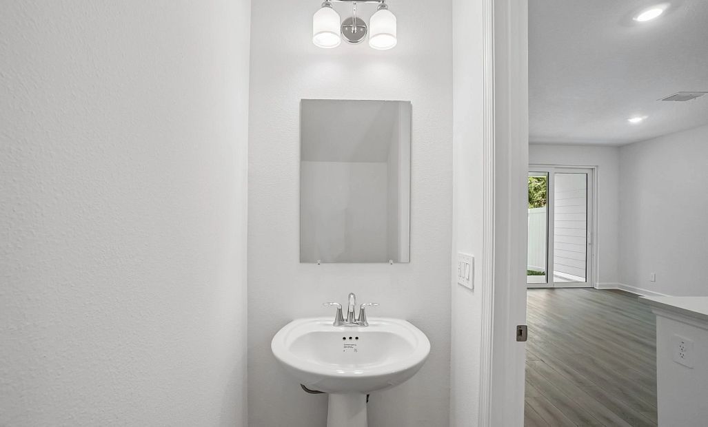 Half bathroom located just off the kitchen on the first floor