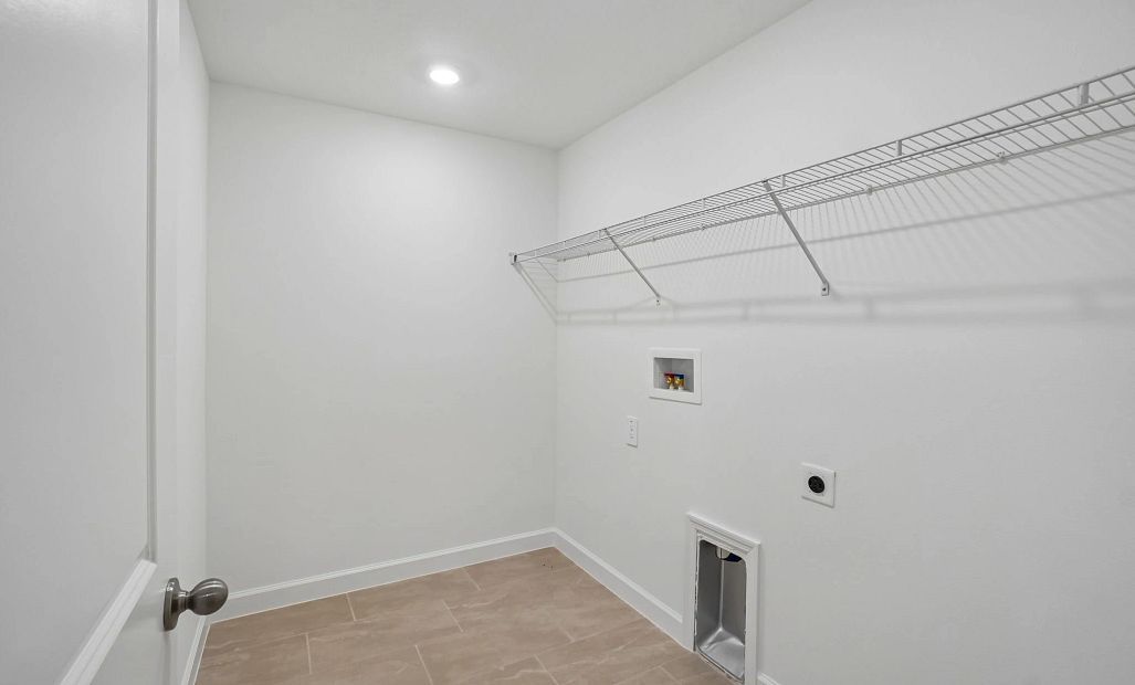 Laundry room located off the upstairs hallway