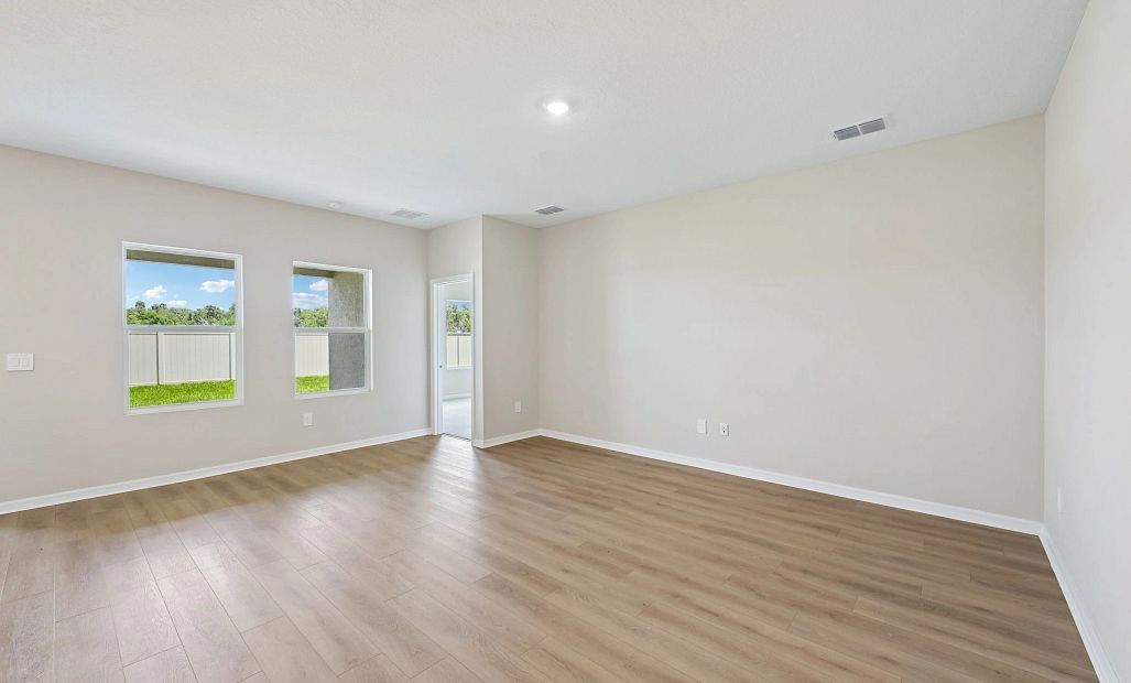 As you continue down the foyer you are welcomed into this large open family room space that is