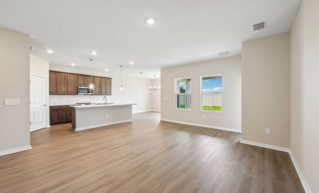 The family room space opens up into the kitchen and dining spaces