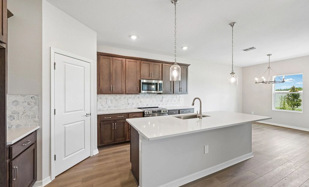 The beautiful kitchen features our AW Collection® Roosevelt and a large island perfect for
