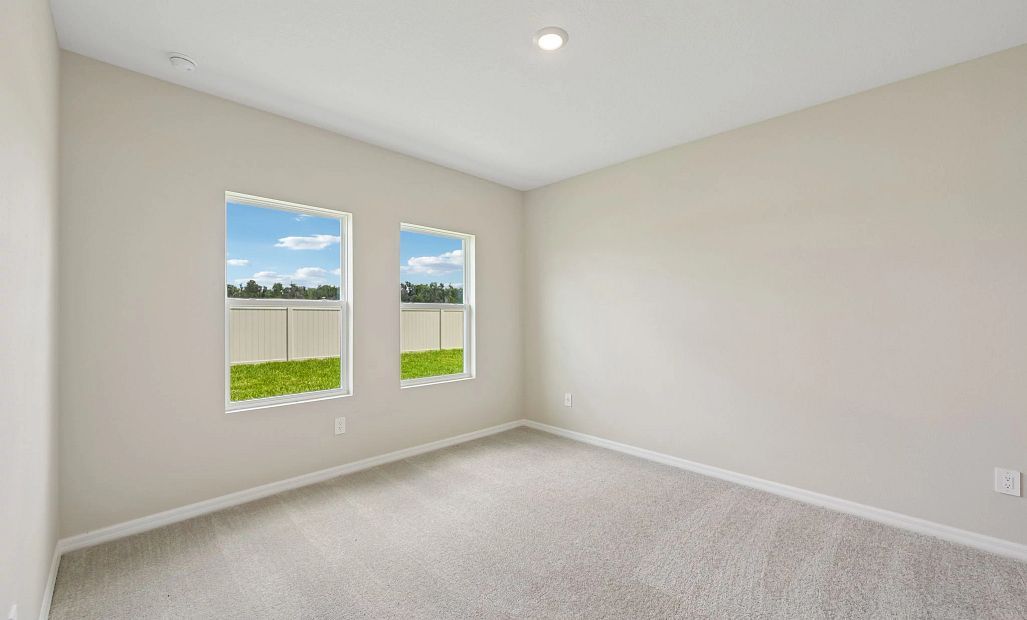 Primary bedroom has two large windows for great natural lighting