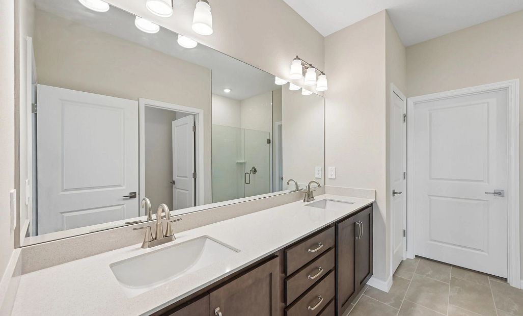 The primary bathroom has double sinks and features aspects of our AW Collection® Roosevelt