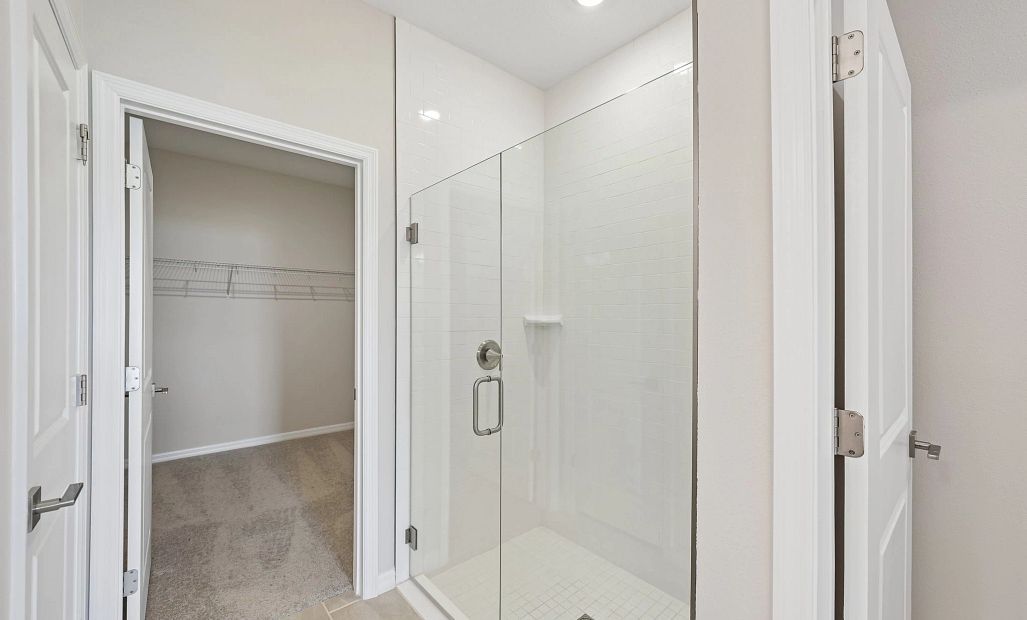 A private water closet and a frameless walk-in shower in the primary bathroom
