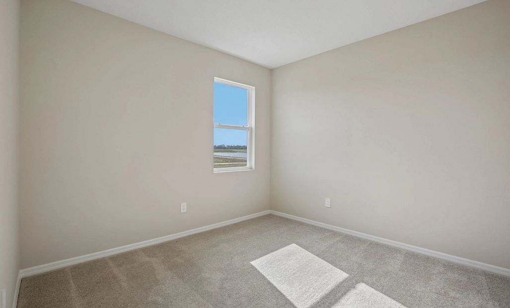 Spacious bedroom 2 located off the side of the home and has a view of the water