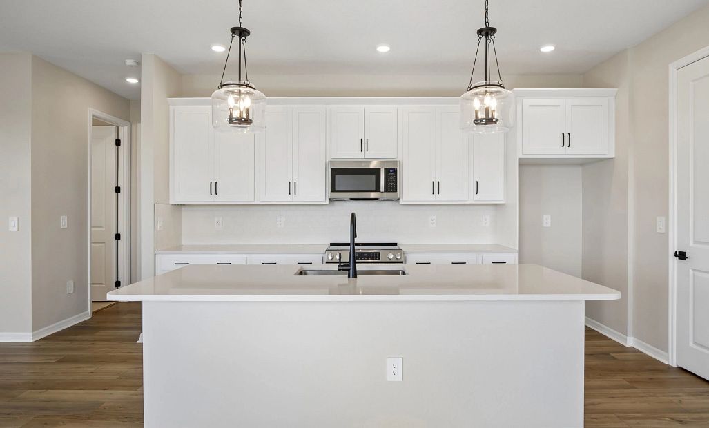 The stunning kitchen features AW Collection® Harmony and a large island