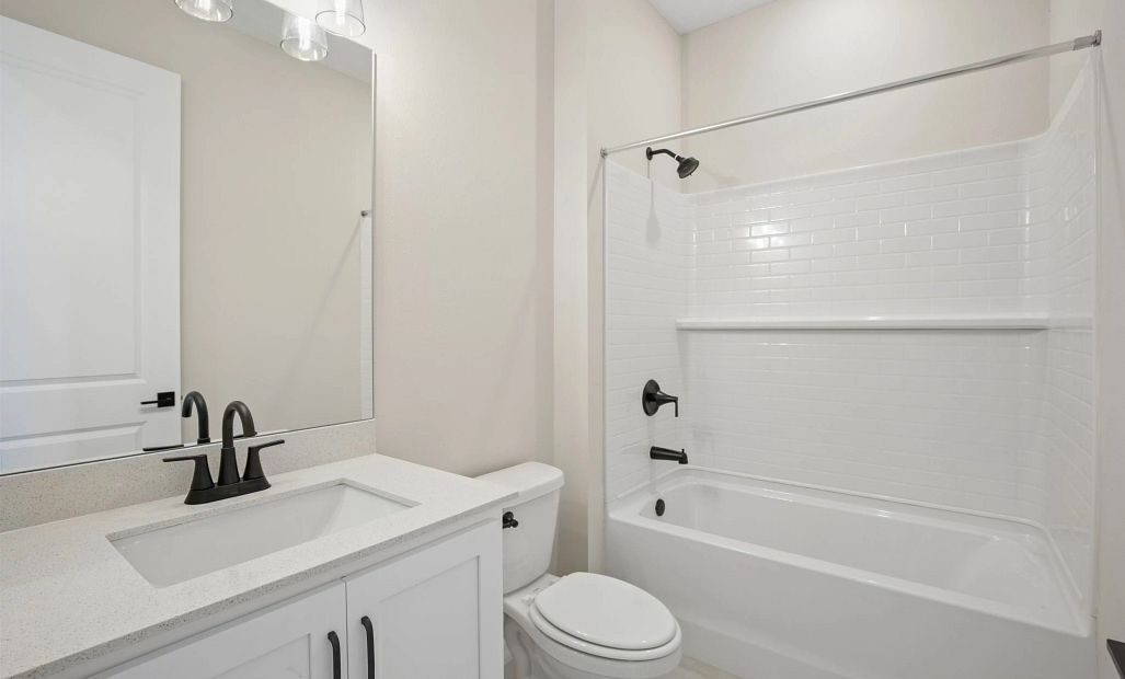 Bathroom 3 is located off the back hallway near bedroom 4