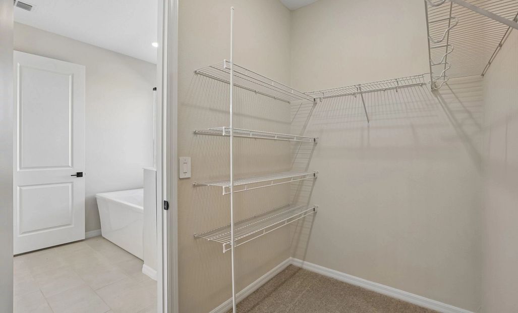 A spacious walk-in closet is located off the primary bathroom