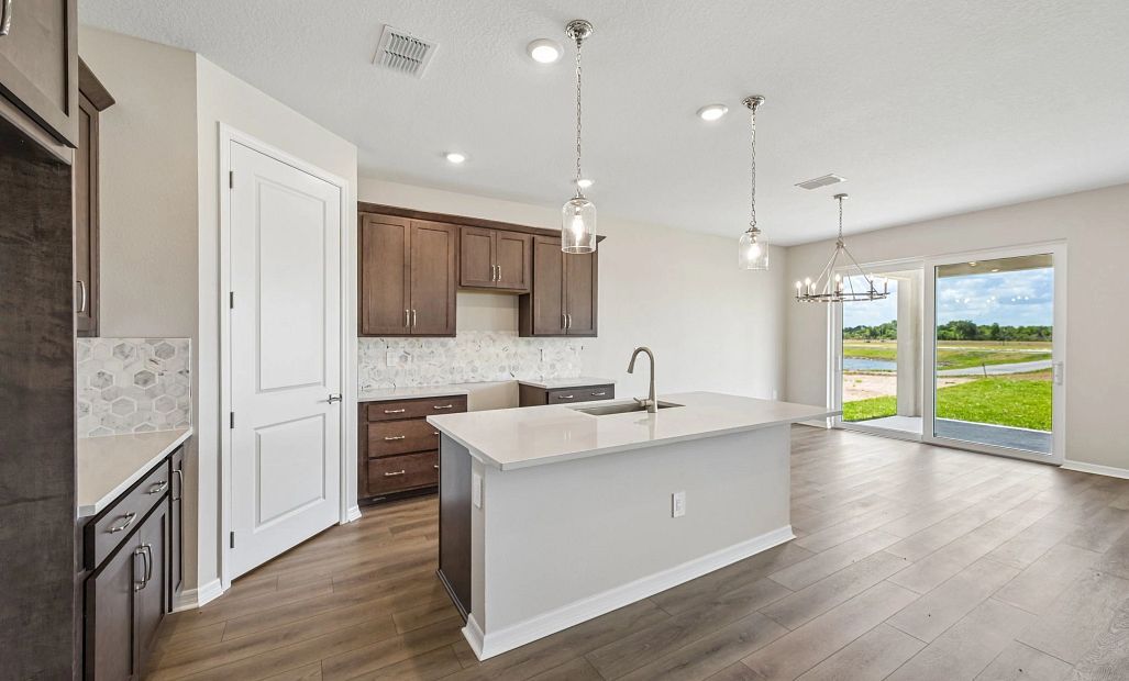As you continue down the foyer you walk into the open kitchen, dining and family room spaces
