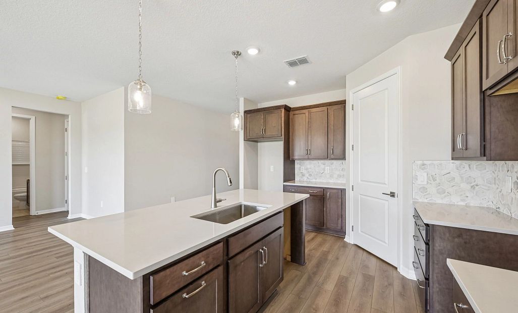 The AW Collection® Roosevelt has a beautiful wood stained cabinet and a cool designed backsplash