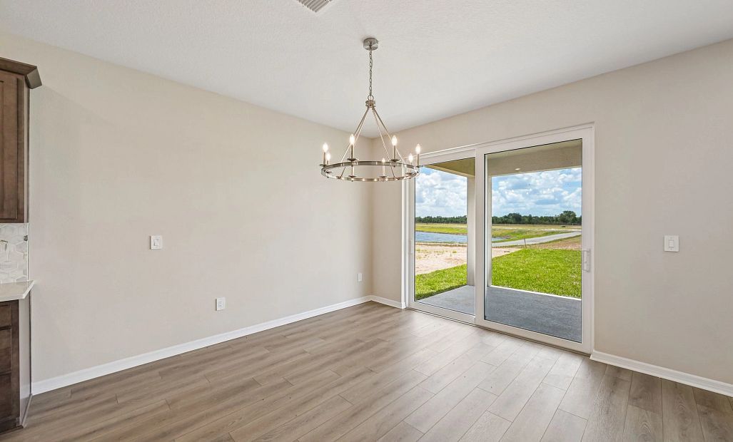 The dining room looks out the large sliding glass door on to the covered lanai