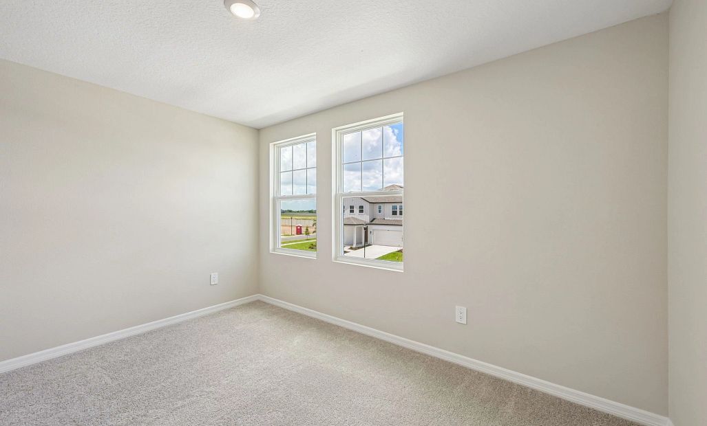 Bedroom 2 is located off the front of the home and features two large windows