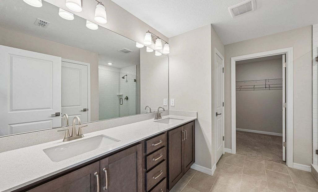 Primary bathroom features aspects of AW Collection® Roosevelt and double sinks