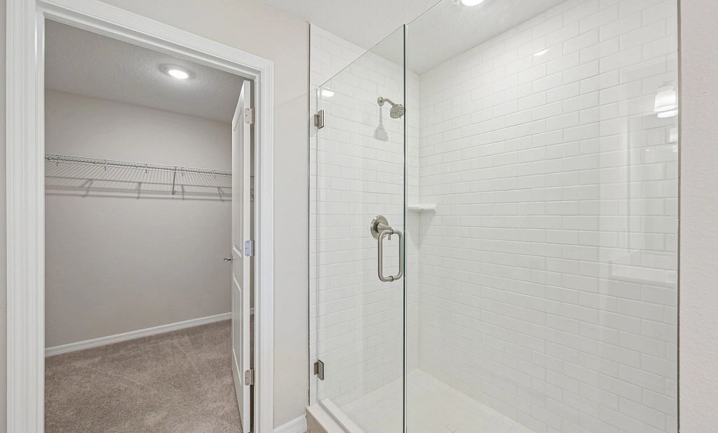 In the primary bathroom you will enjoy a large frameless walk-in shower