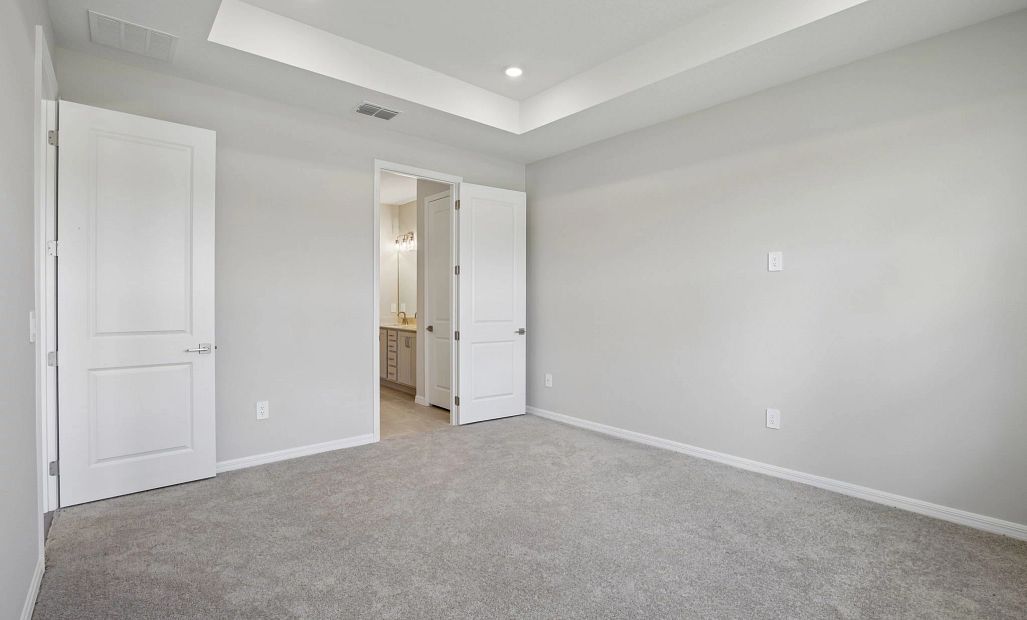 The tray ceiling in the primary bedroom really make this space feel grand