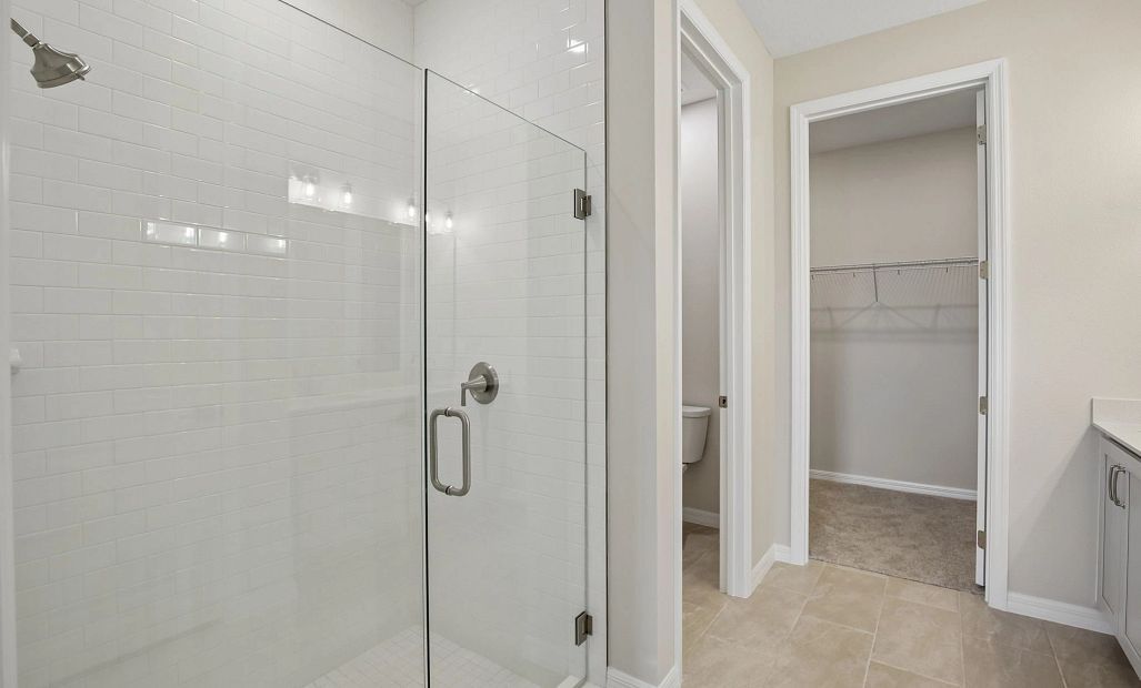 In the primary bathroom you will find a separate water closet and a frameless walk-in shower